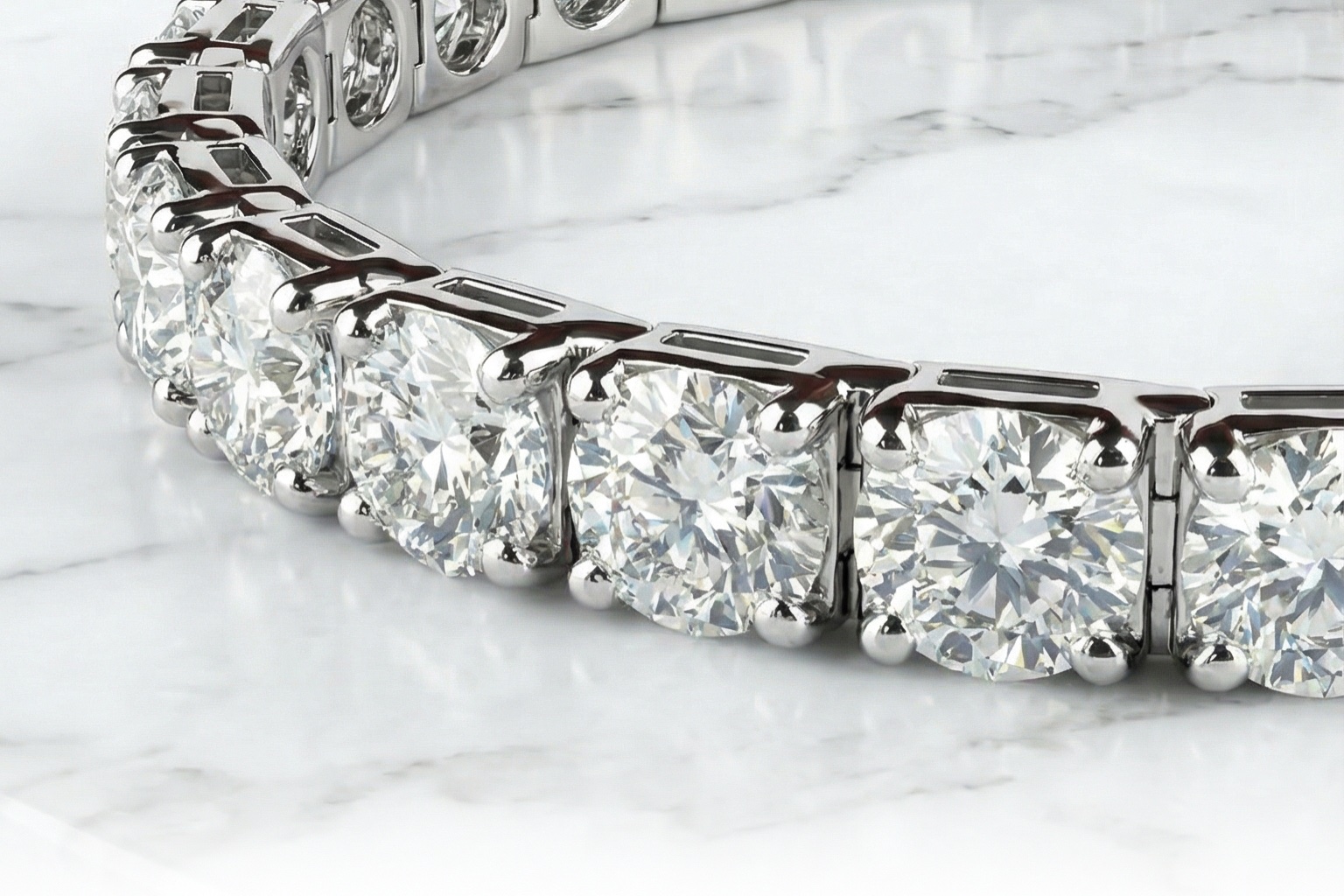 A lab-grown diamond tennis bracelet in white gold, resting on white marble