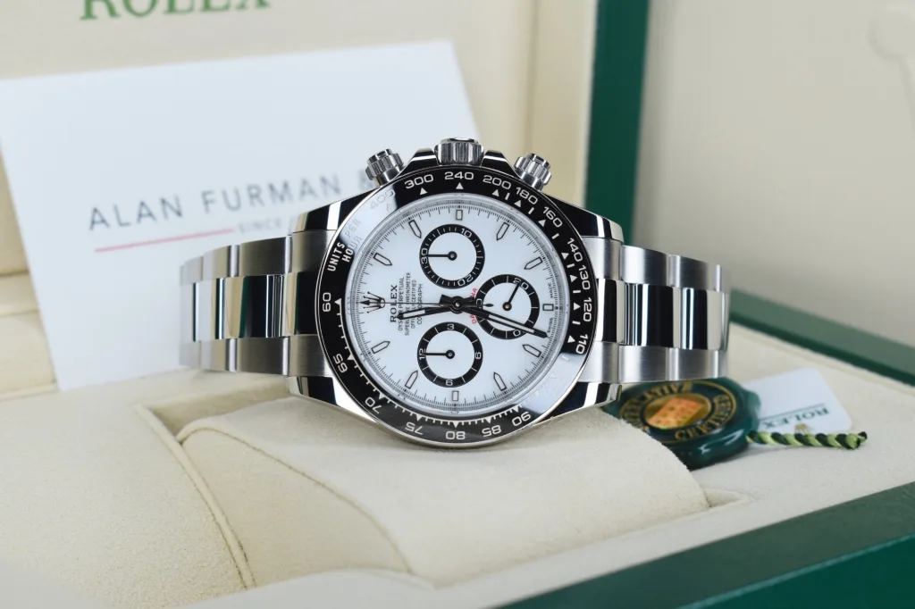 116500LN vs 126500LN: the Rolex Cosmograph Daytona 126500LN-0001 in its box at the Alan Furman & Co showroom, showing the polished steel band around the black ceramic bezel